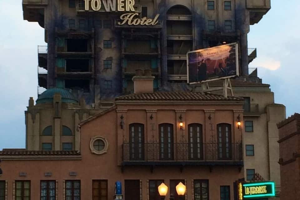 The Hollywood Tower Hotel with a sign that reads "The Hollywood Tower Hotel" and a billboard advertising "Jimmy Buffett."