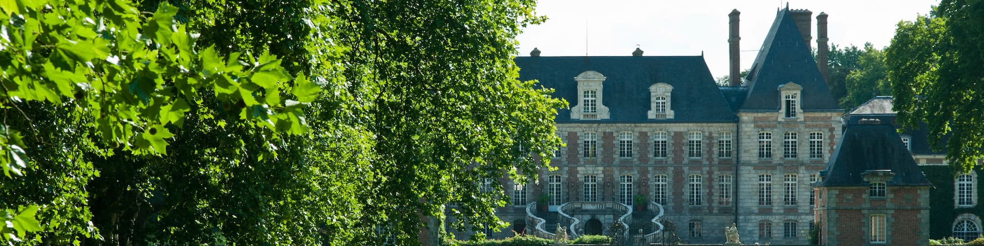 A historic building with a moat and chain-guarded water feature.
