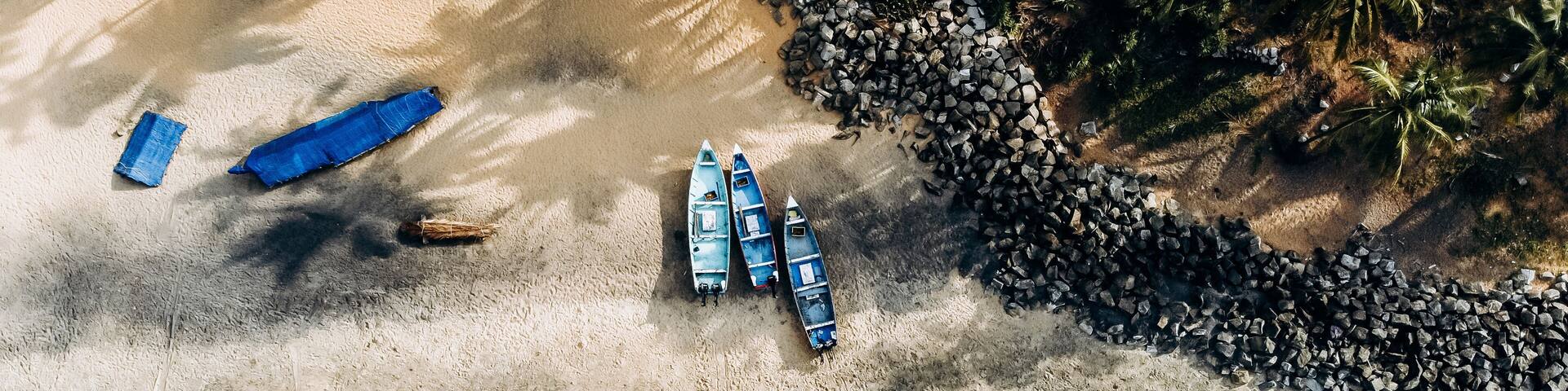 Beautiful Indian beach. Girl on beach. Boats