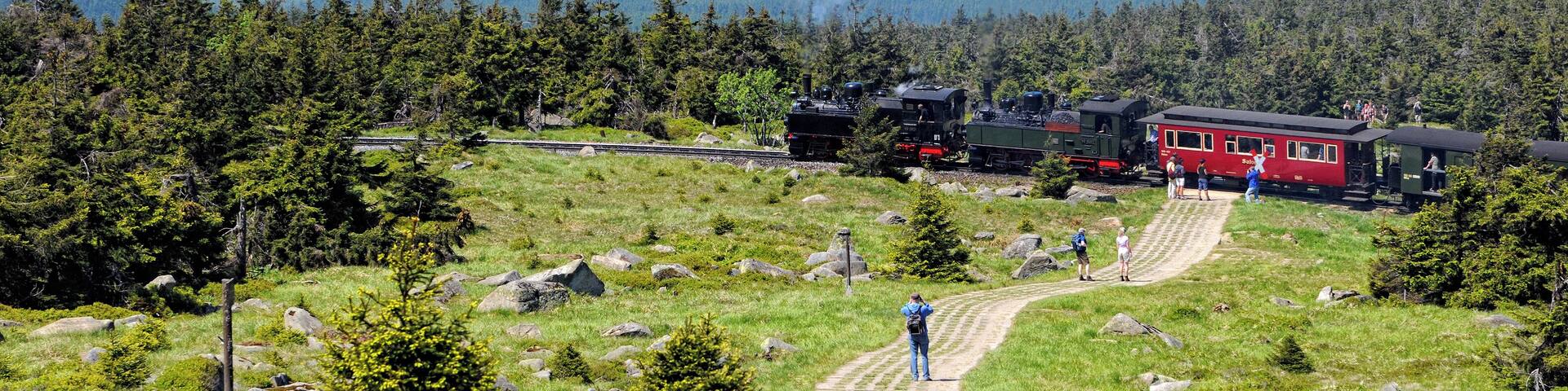 BROCKEN MOUNTAIN, SAXONY-ANHALT/ GERMANY May 26 2012: historical locomotive is going up high to Brocken Peak with tourists. Brocken is part of Harz National Park.