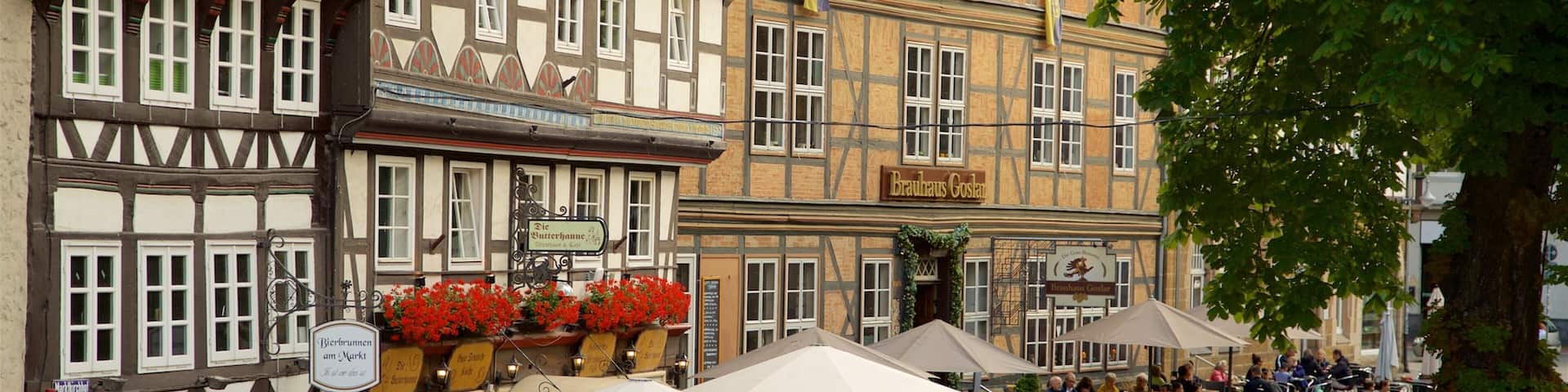 A bustling outdoor café with traditional half-timbered buildings in the background.