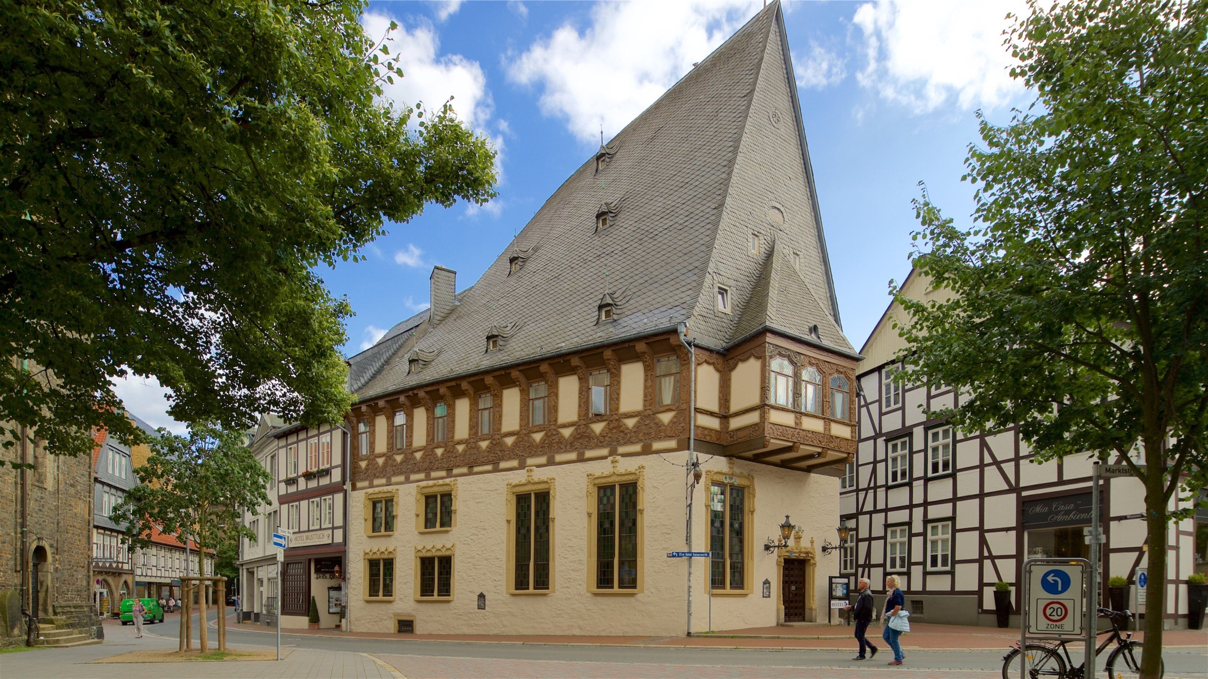 A historic building with a steeply pitched roof and timber framing.