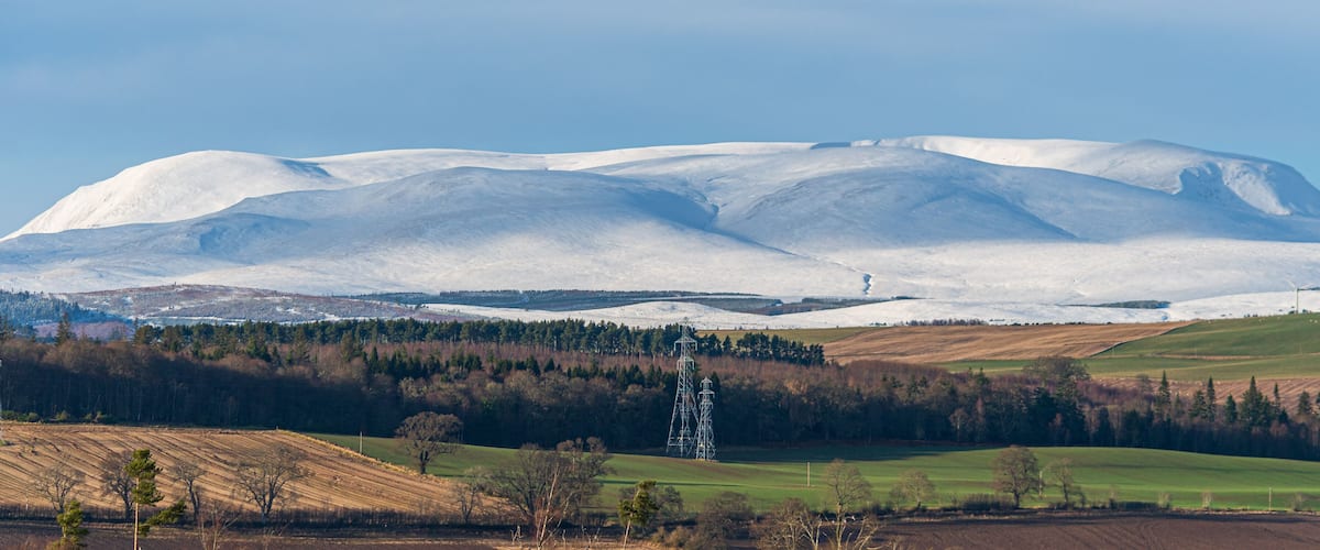 A snow-covered mountain with a clear sky.