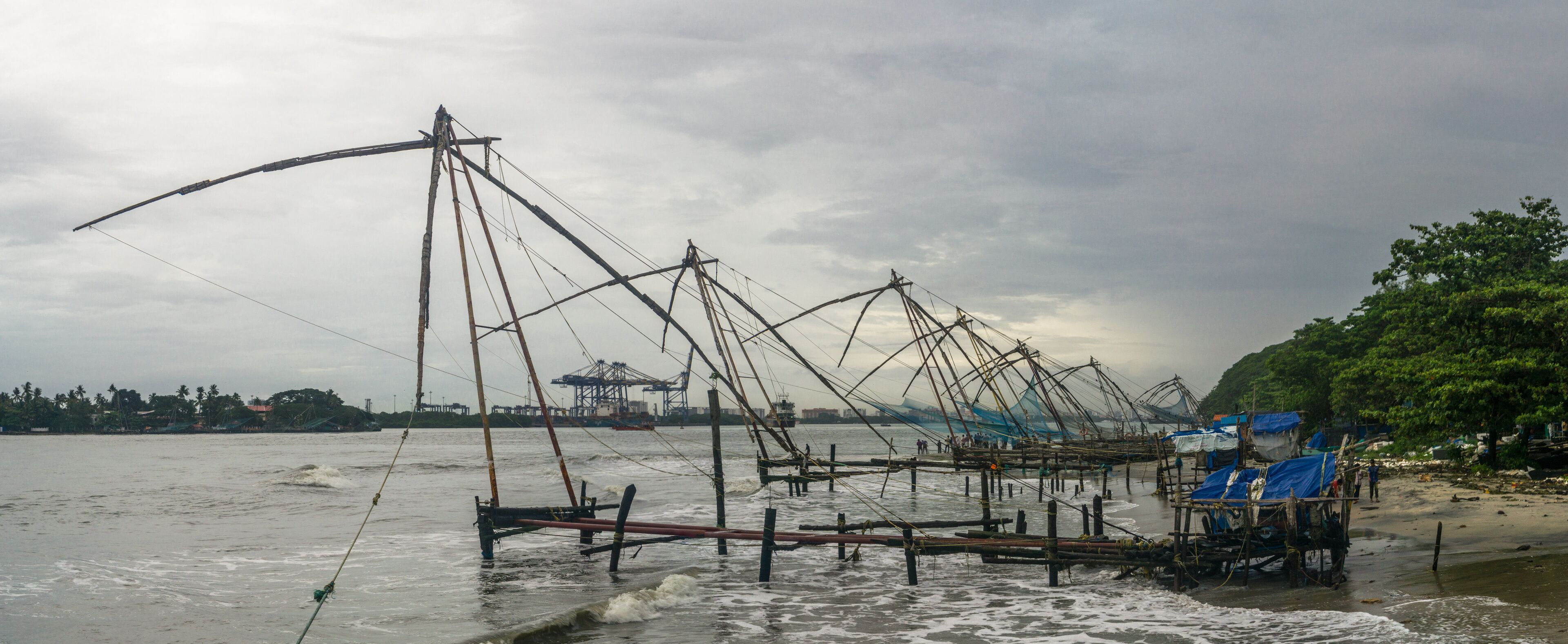 A coastal fishing area with numerous fishing nets and boats.