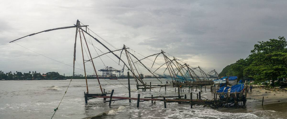 A coastal fishing area with numerous fishing nets and boats.