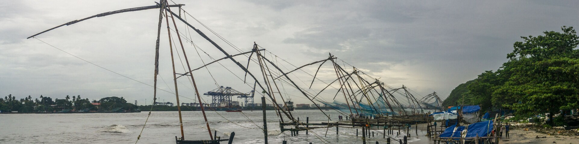 A coastal fishing area with numerous fishing nets and boats.