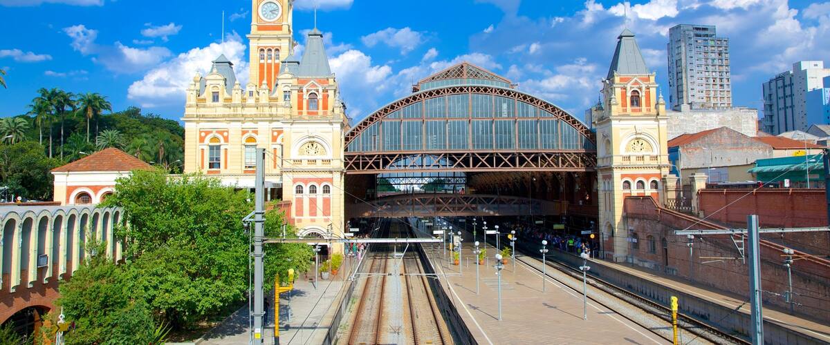 A historic train station with a clock tower and a large arched entrance.
