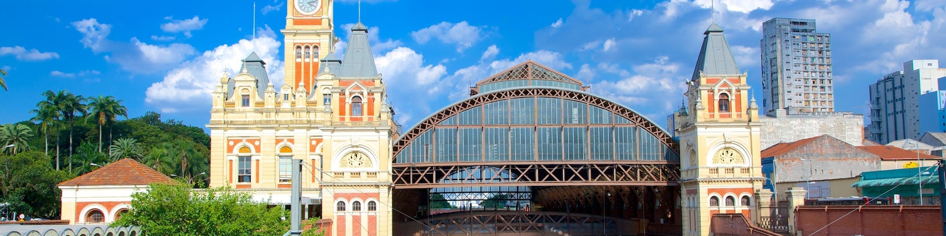 A historic train station with a clock tower and a large arched entrance.