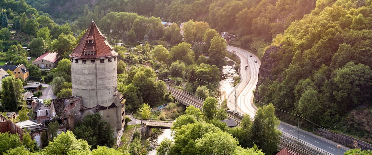 A tower, a winding road, and a river.