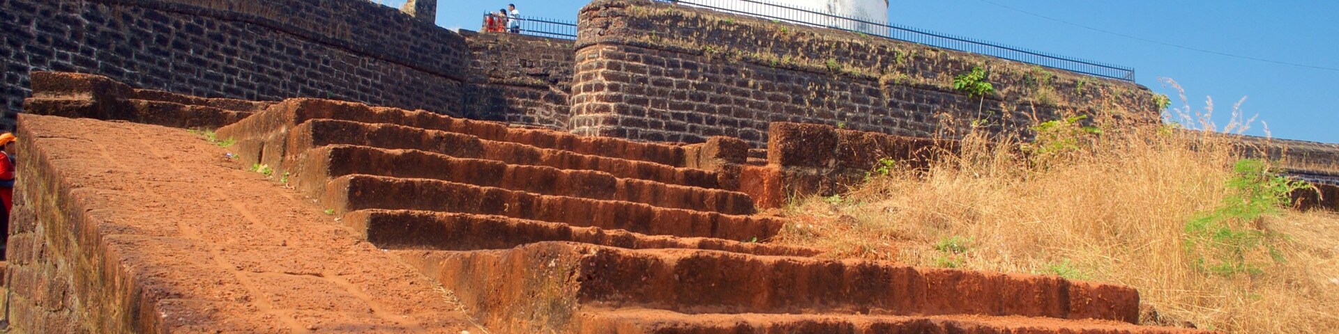 Una fortaleza histórica con una gran cúpula blanca y una serie de escalones de ladrillo rojo que conducen a ella.