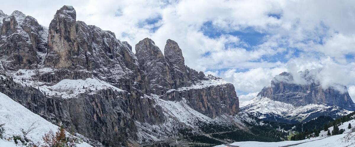 Snow-covered mountains, a valley, and a small village with buildings.