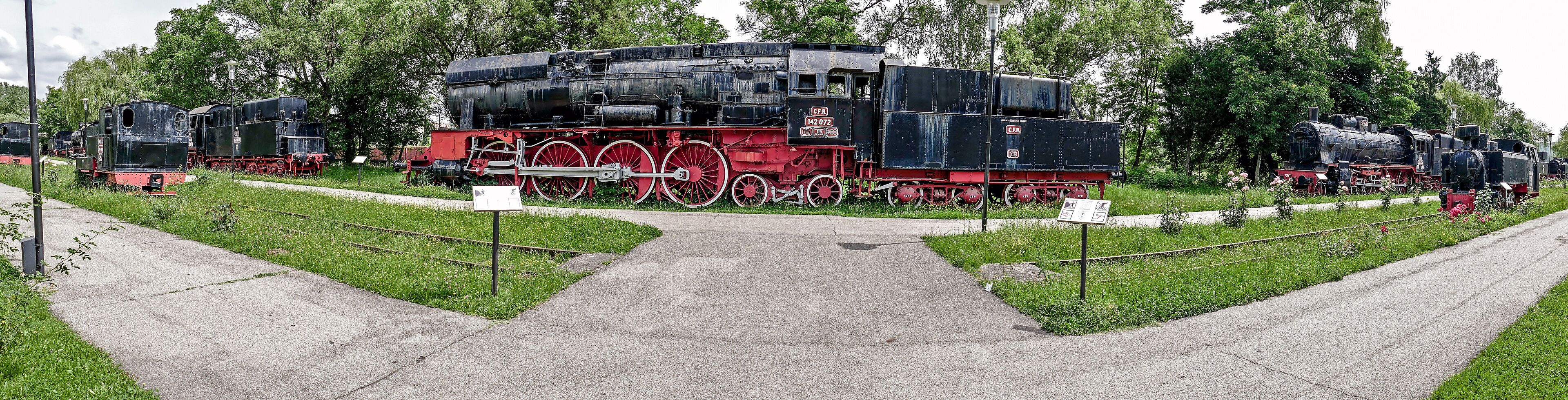 A railway museum with vintage steam locomotives on display.