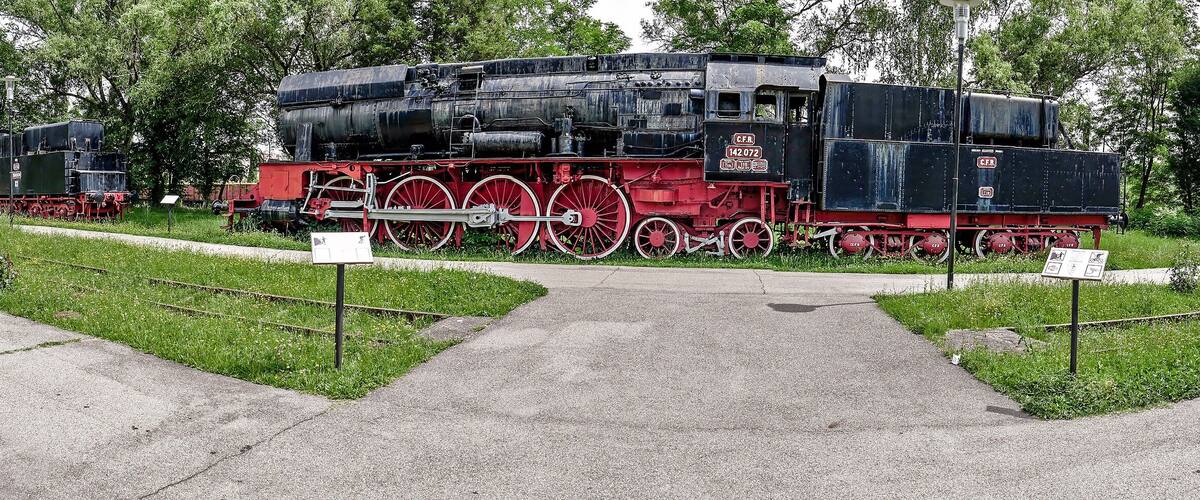 A railway museum with vintage steam locomotives on display.