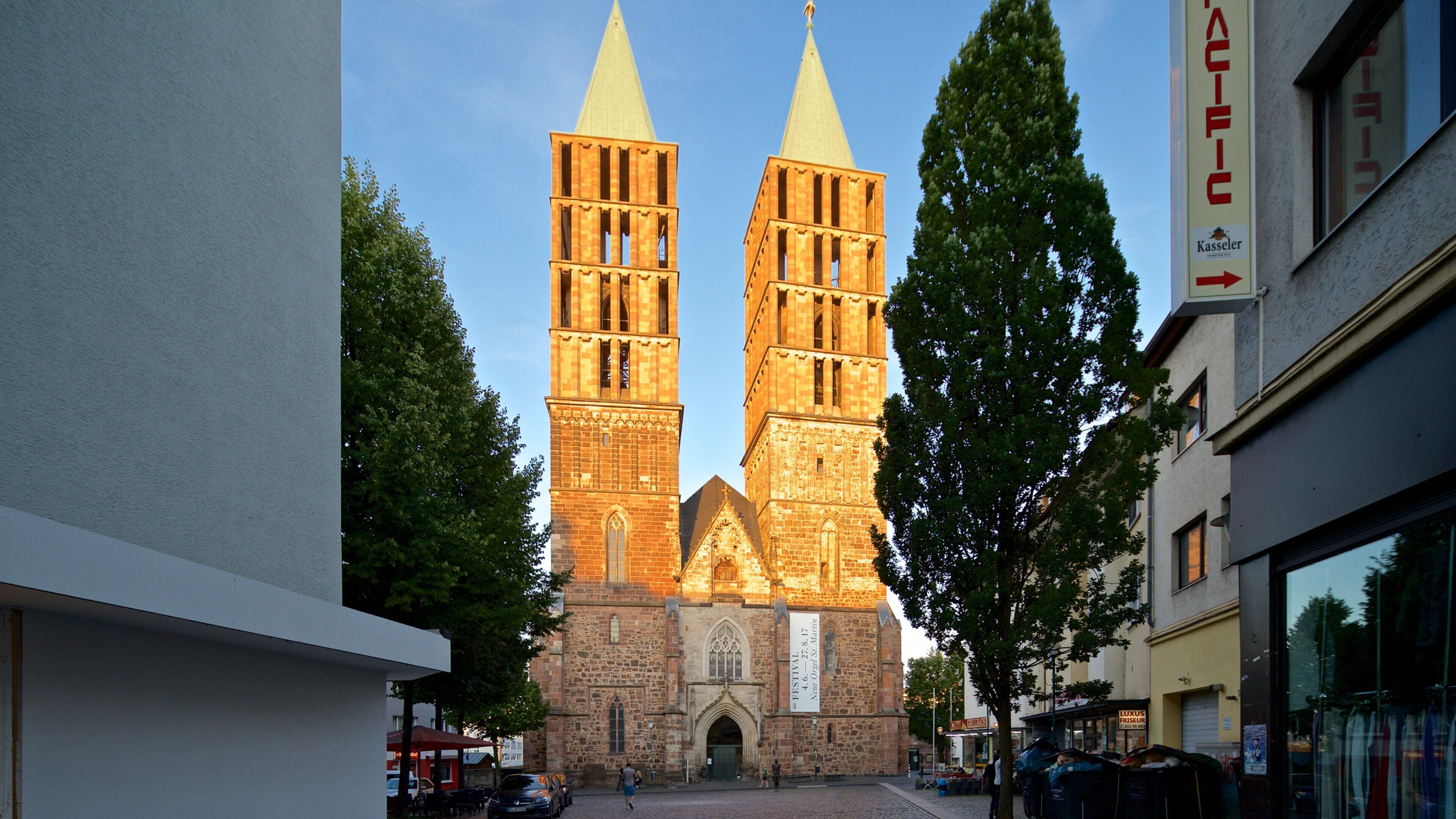 A historic church with two tall spires and a large banner.