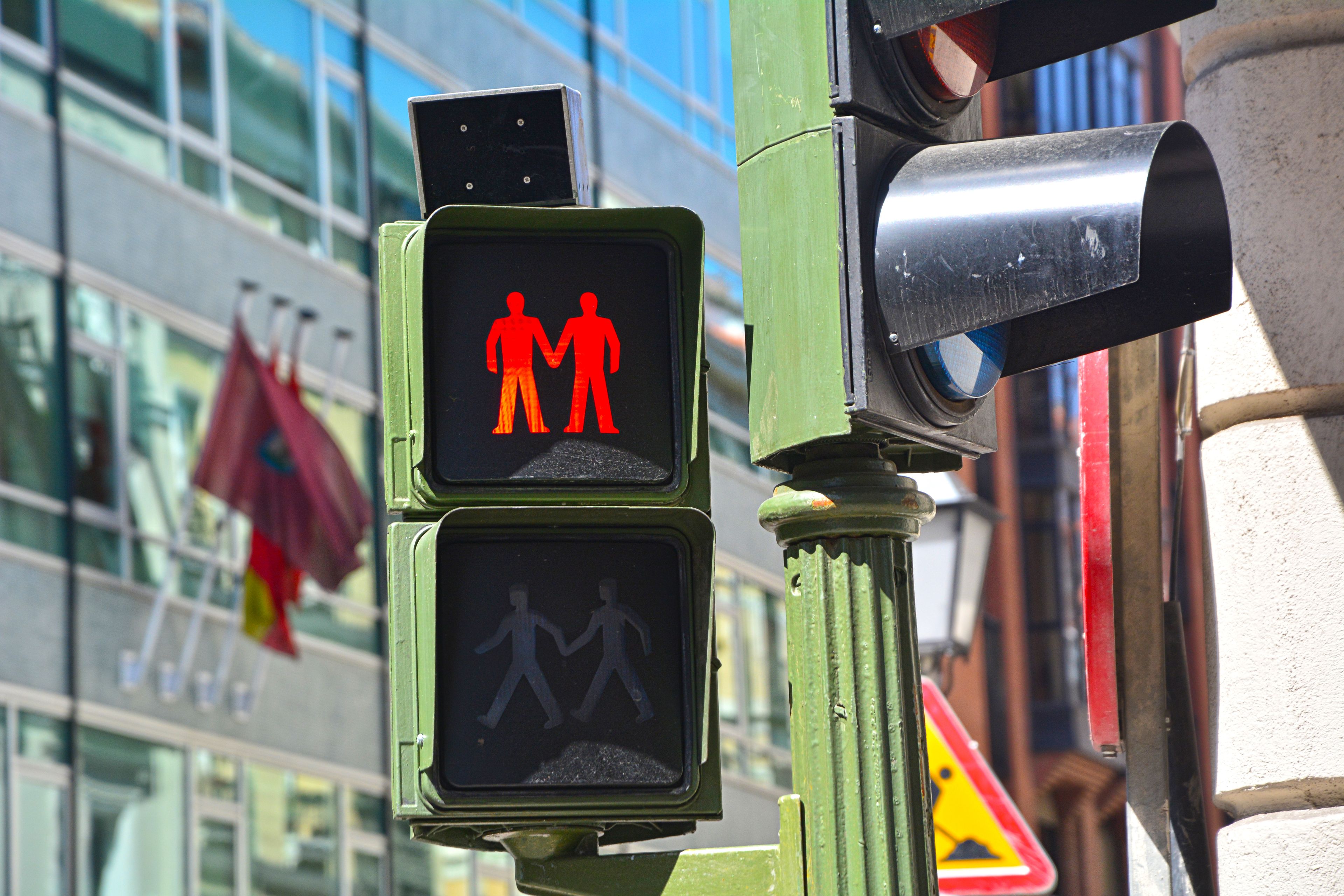 Red traffic light with a same-sex couple for Pride festival in Madrid's Chueca gay district