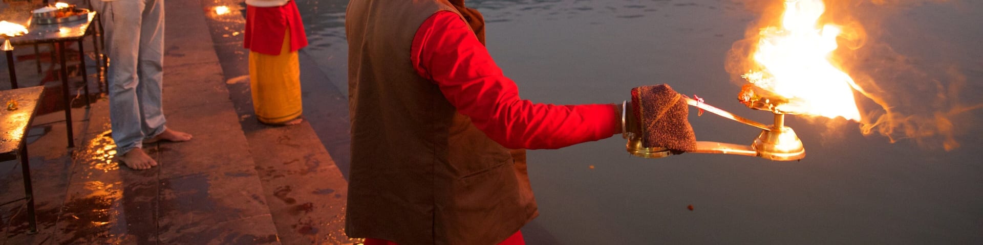 Triveni Ghat which includes a river or creek and religious aspects as well as a small group of people