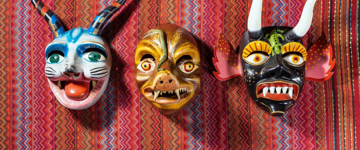 Three colorful masks with distinct designs and features.