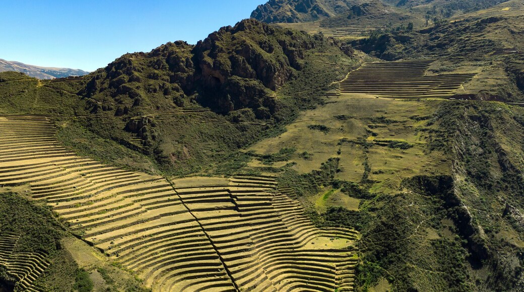 Aerial panoramic view of the ancient Inca ruins of Pisac (Pisaq) in the Sacred Valley near Cusco, Peru. Archaeological park with green terraces.
