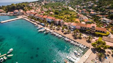 Trpanj Waterfront Aerial View, Peljesac Peninsula, Southern Croatia. Picturesque Coastal Village with Palm Lined Promenade, and Blue Adriatic Waters