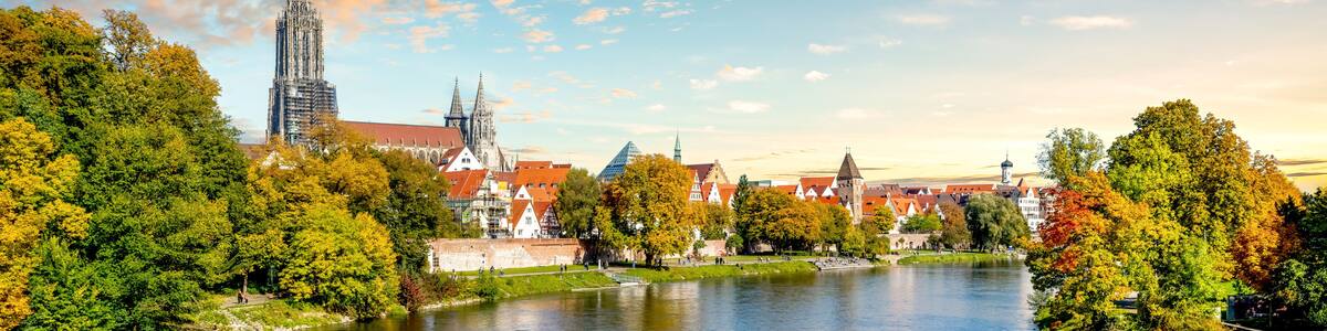 A river with a castle and spires in the background.