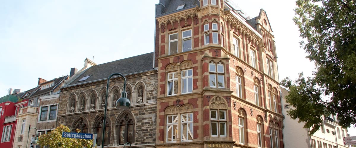 A historic building with intricate architectural details, including arched windows and decorative stonework.