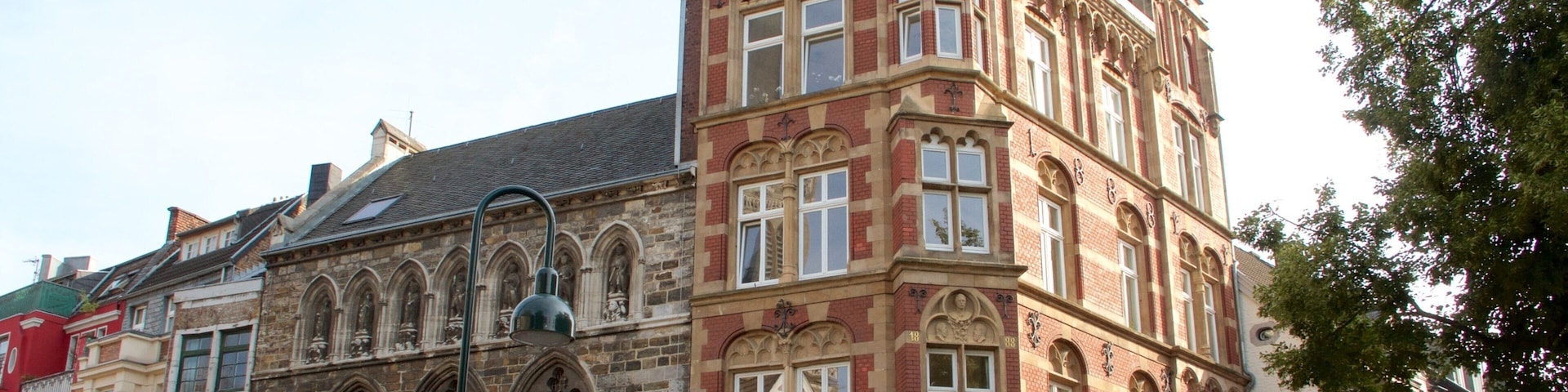 A historic building with intricate architectural details, including arched windows and decorative stonework.