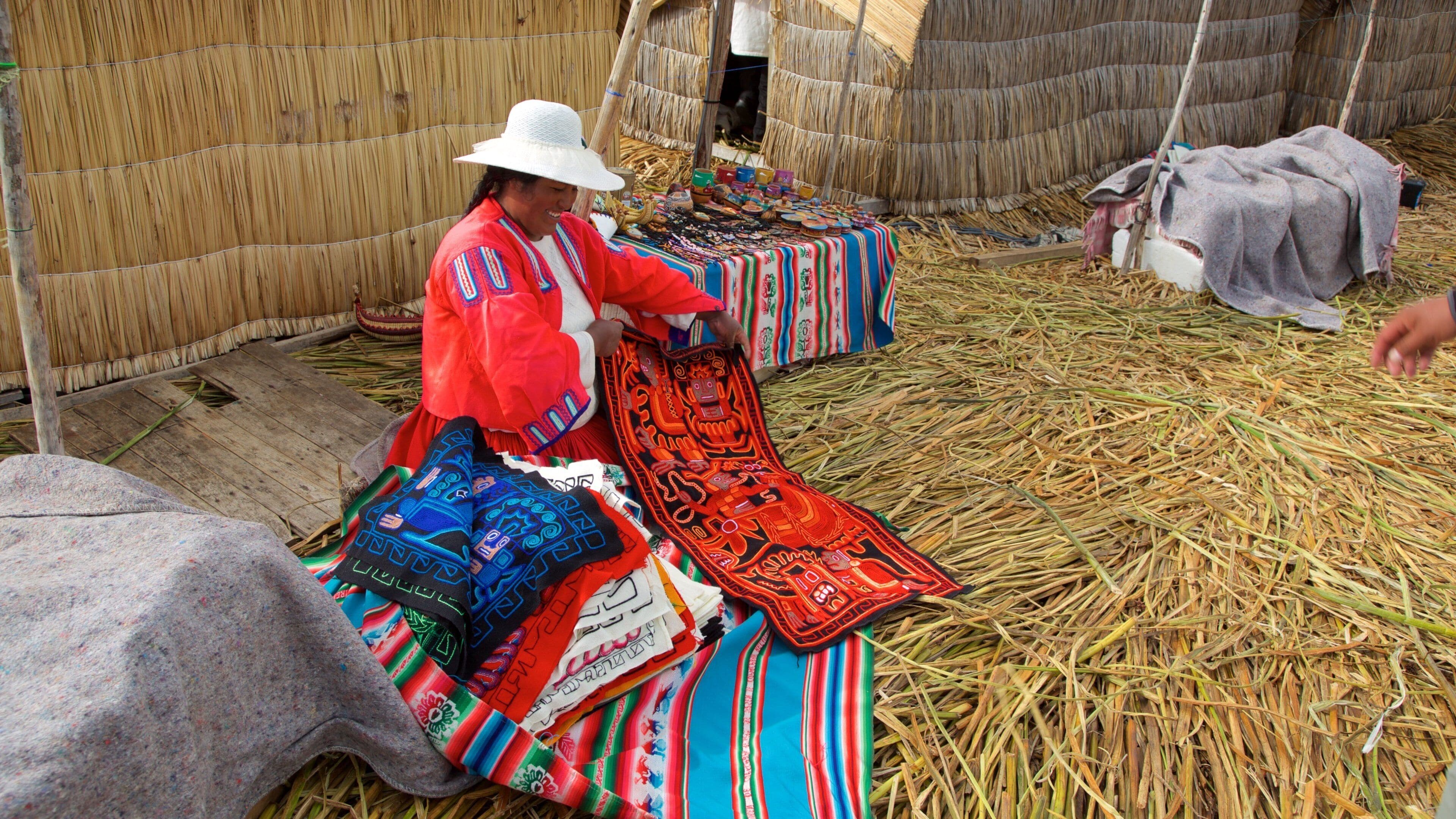 Lake Titicaca showing a small town or village as well as an individual female