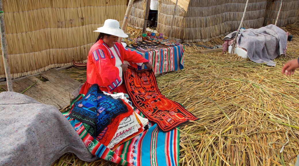 Lake Titicaca showing a small town or village as well as an individual female