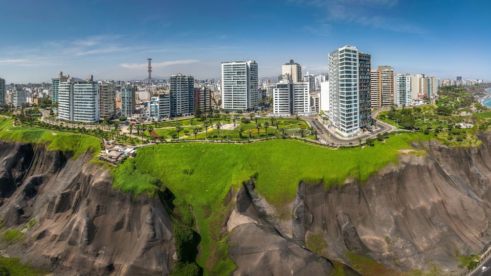 LIMA, PERU: Aerial view of Miraflores town, cliff and the Costa Verde high way