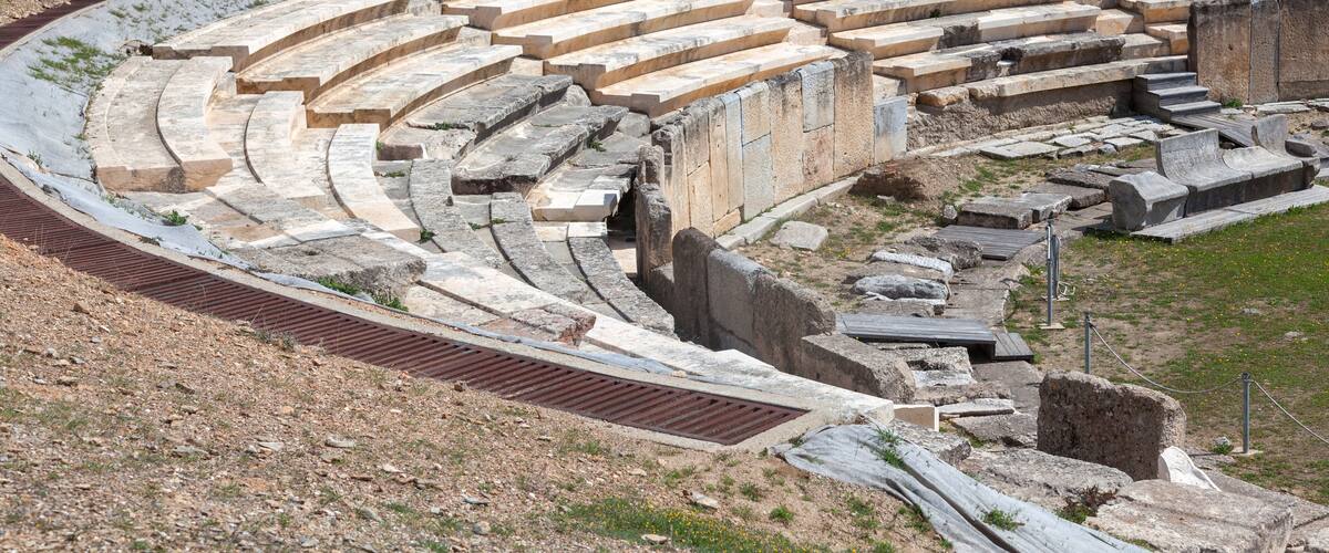 A semi-circular stone amphitheater with tiered seating.