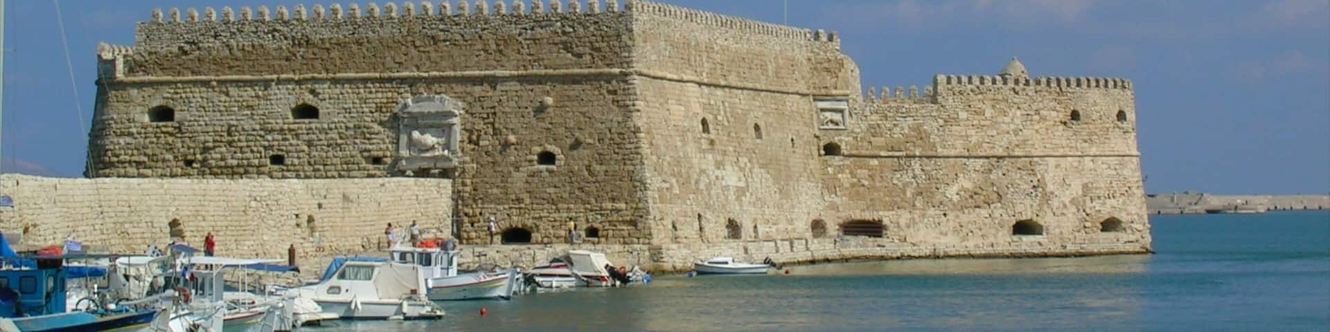 Heraklion featuring chateau or palace, a marina and heritage architecture