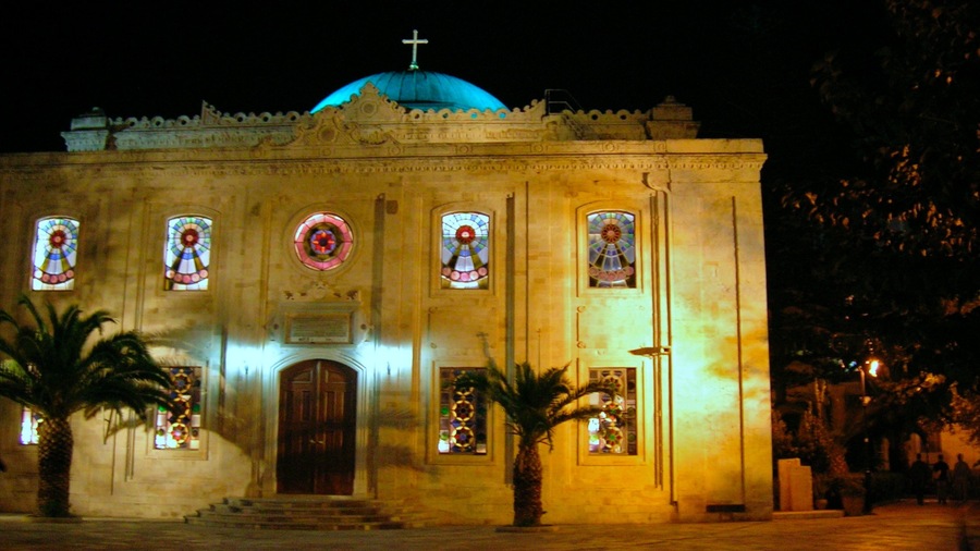 Una iglesia con una cúpula azul y vidrieras.