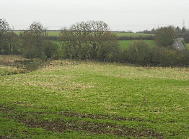 Brook and Fields Located close the Northern boundary of Milton Keynes, this is still unspoilt countryside and the Brook (or small stream) can be seen to the left of frame. The road leaves to Haversham (and Milton Keynes).