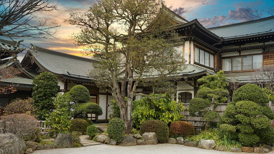 Beautiful shot of a Japanese house with a tree garden under the cloudy sky in Kawagoe, Japan