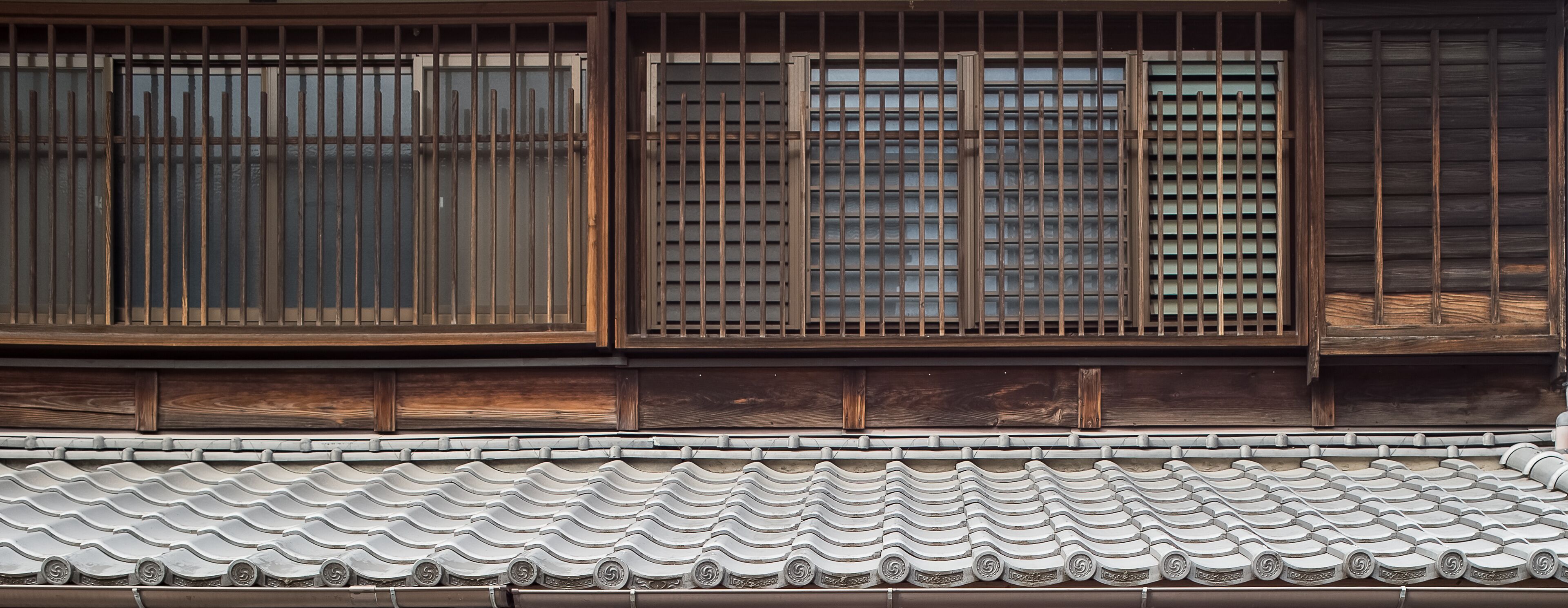 A traditional Japanese building with wooden sliding doors and tiled roof.