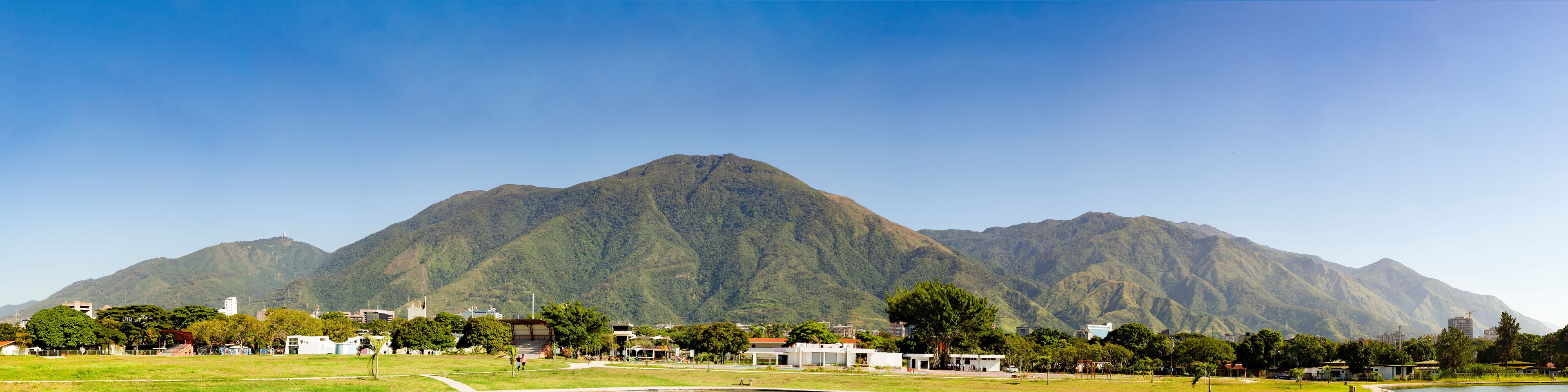 A mountainous landscape with a town in the foreground.