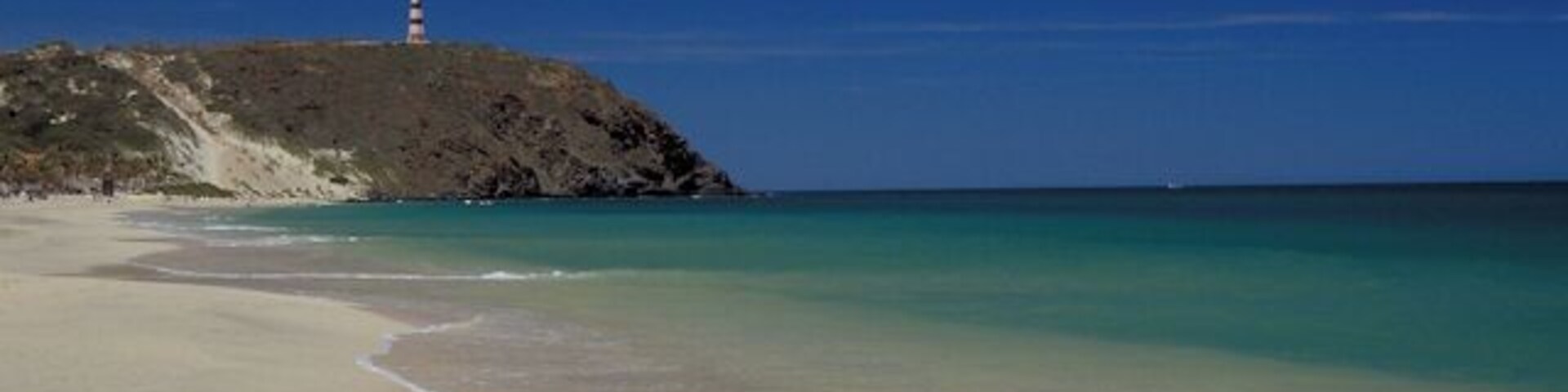 Puerto Cruz beach on the northeast end of the island looking towards the lighthouse on Punta Zaragoza.