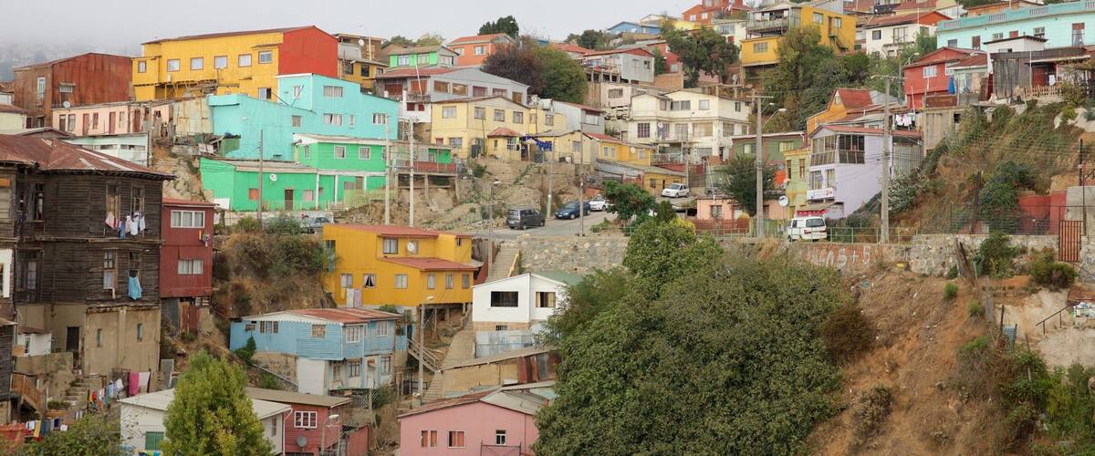 A densely packed hillside town with colorful buildings and steep terrain.
