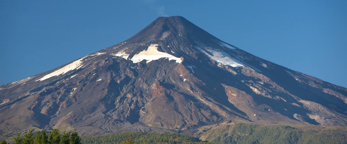 A snow-capped mountain with a clear sky.