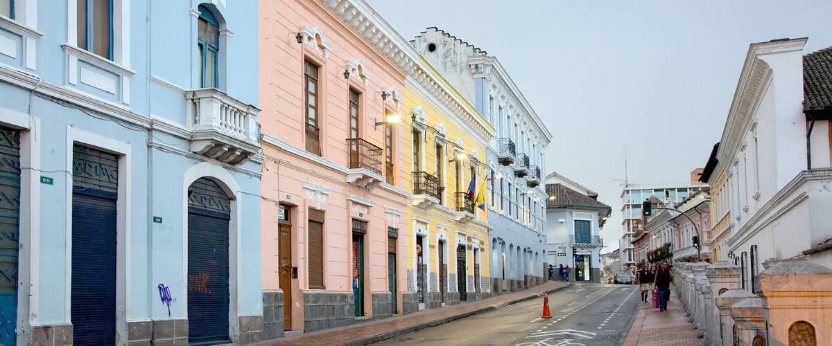 A street lined with colorful buildings, a bicycle lane, and a sidewalk.