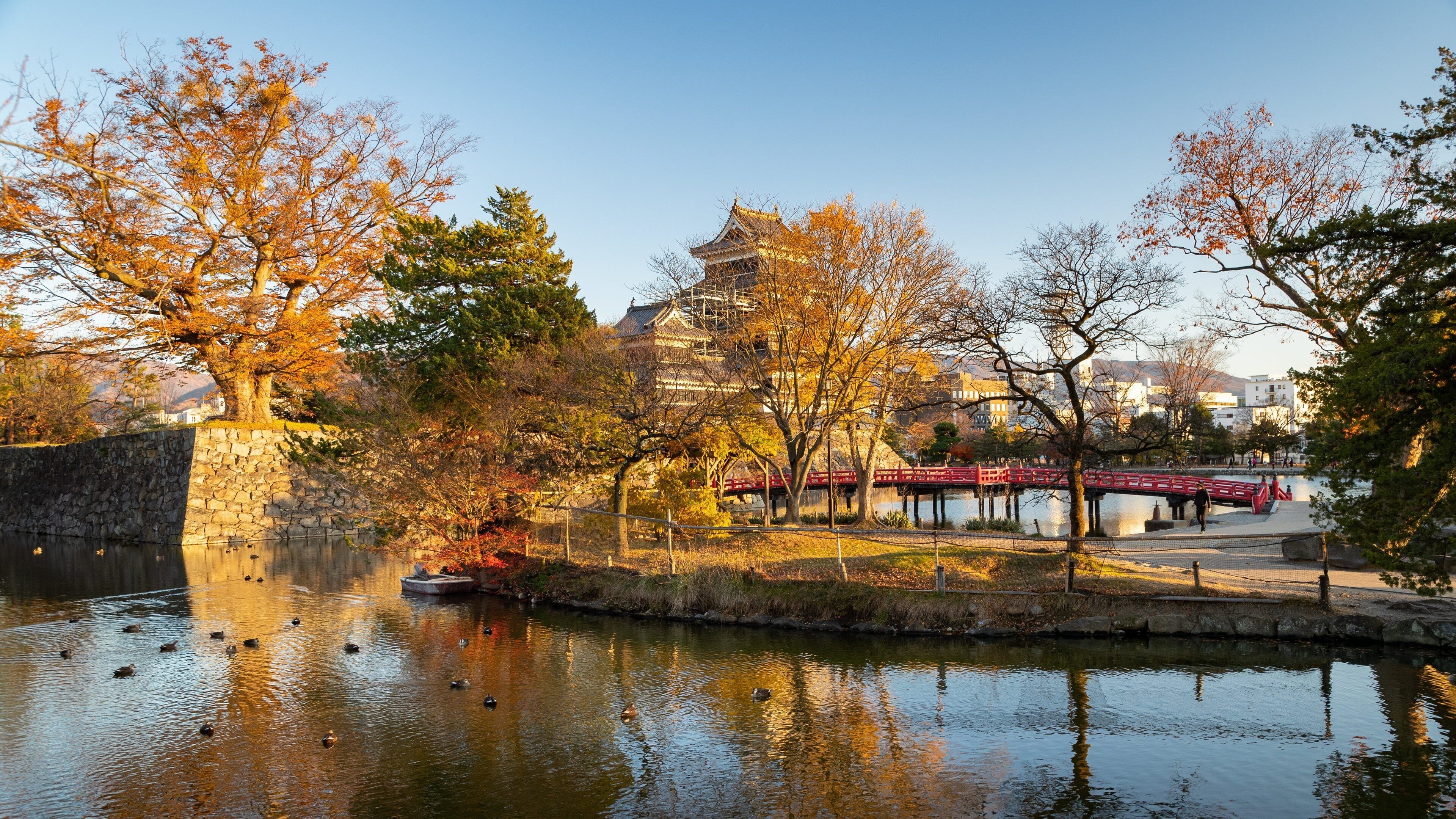Matsumoto featuring a sunset, heritage architecture and a pond