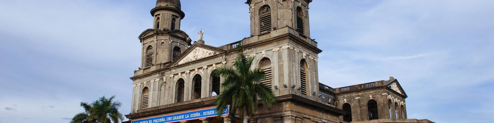 A historic church with two domes and a large bell tower.