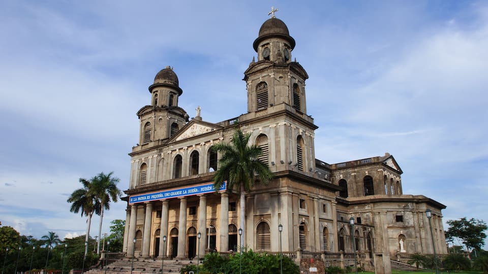 A historic church with two domes and a large bell tower.