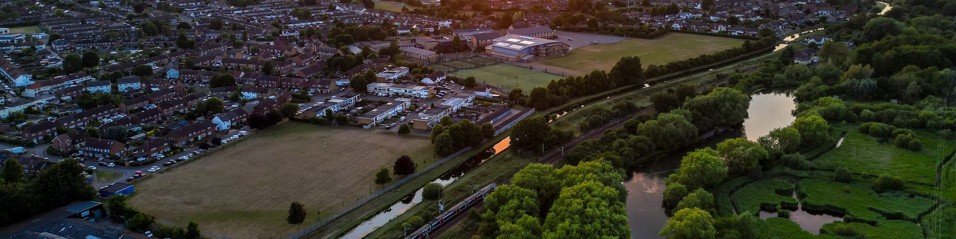 Aerial view of Hoddesdon, Hertfordshire showing river, sunset and housing estate