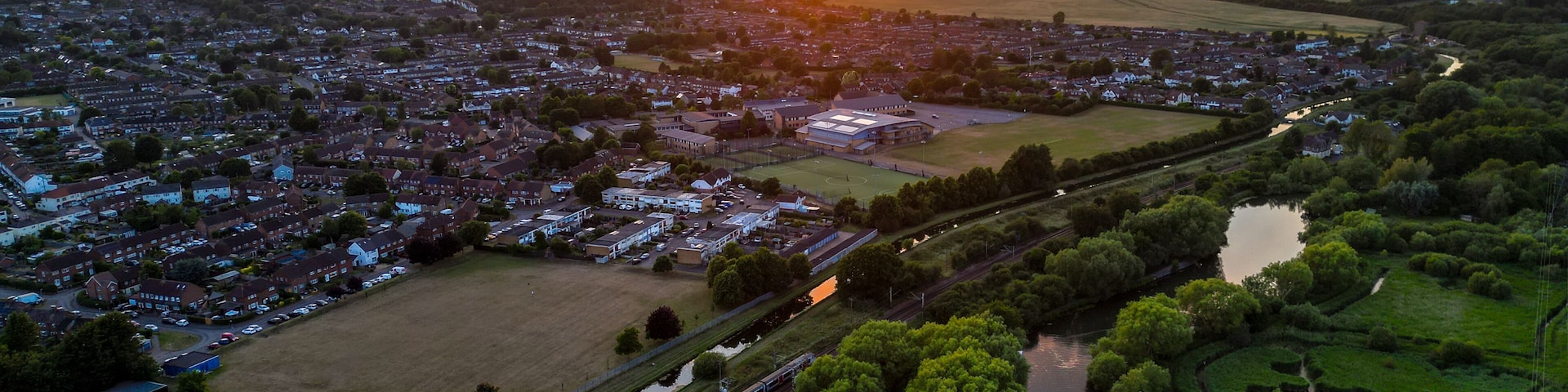 Aerial view of Hoddesdon, Hertfordshire showing river, sunset and housing estate