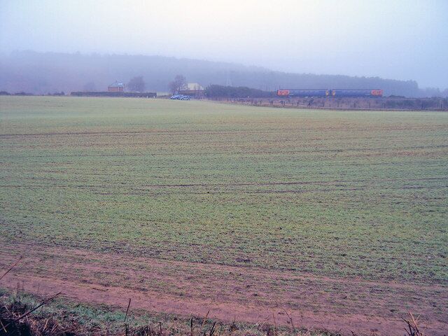 The Robin Hood Line Looking east to a train on the embankment of the Robin Hood Line, which runs north of Nottingham along the former Midland Railway main line. In the mist at the back are Robin Hood's Hills. The Nottingham-Mansfield-Worksop passenger service was withdrawn in October 1964, closing this route which had existed for 115 years and leaving Mansfield as the largest town in Britain without a railway station. The track remained since it was required for coal traffic but goods yards were relentlessly closed along with some of the older collieries. The Annesley Tunnel and its approach cuttings were gradually filled with spoil and refuse. European money for the project looked promising and in July 1990 an Act for the Newstead-Kirkby link was acquired by British Rail. The name 'Robin Hood Line' was adopted and a consortium of local authorities gave the final go-ahead a year later. http://www.wagonplate9.co.uk/The%20Robin%20Hood%20Line/Robin%20Hood%20Line%20Web%20Pages/Construction.htm http://www.wagonplate9.co.uk/The%20Robin%20Hood%20Line/Robin%20Hood%20Line%20Web%20Pages/Stage%202.htm