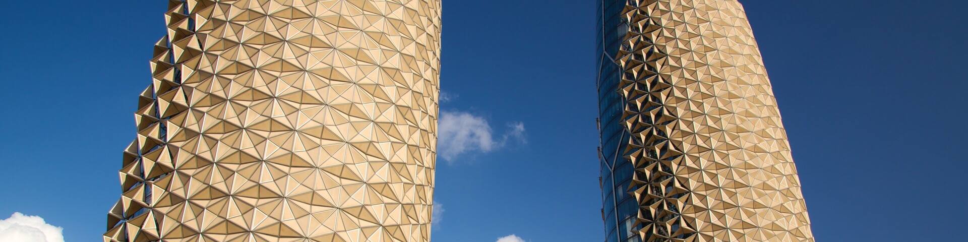 Two tall buildings with a geometric facade.