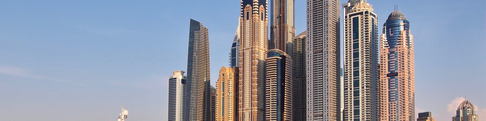 Yacht and skyline at the marina area in Dubai, United Arab Emirates.