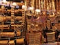 A display of various gold jewelry items, including bangles, necklaces, and earrings, in a store.