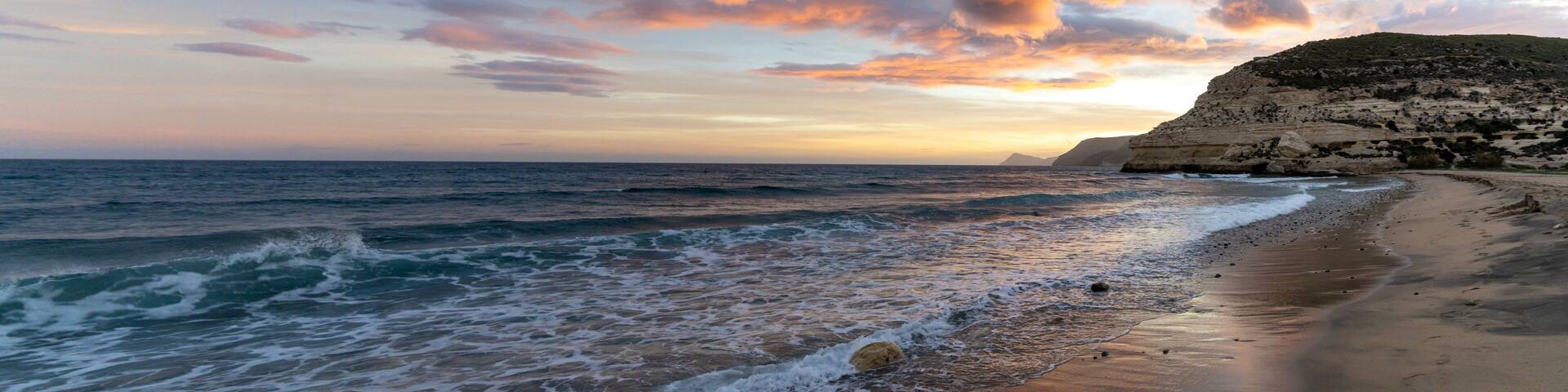 beautiful panorama ocean sunset on the Costa del Sol in Spain with beach and cliffs in the background